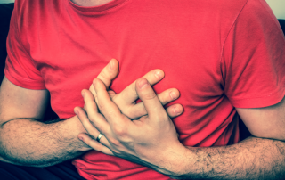 a man with chest pain & symptoms of a heart attack