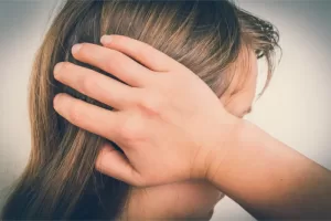 A woman suffering from nerve pain and facial pain due to Trigeminal Neuralgia